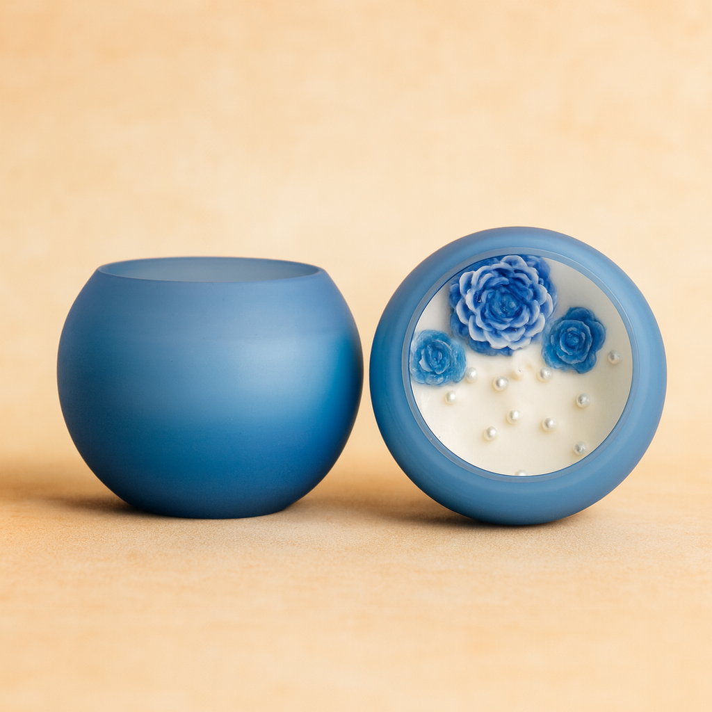 “Blue Bloom Aura Candle by Karigar Kutir – handmade round jar candle with blue floral wax art and pearls for festive decor and gifting.”