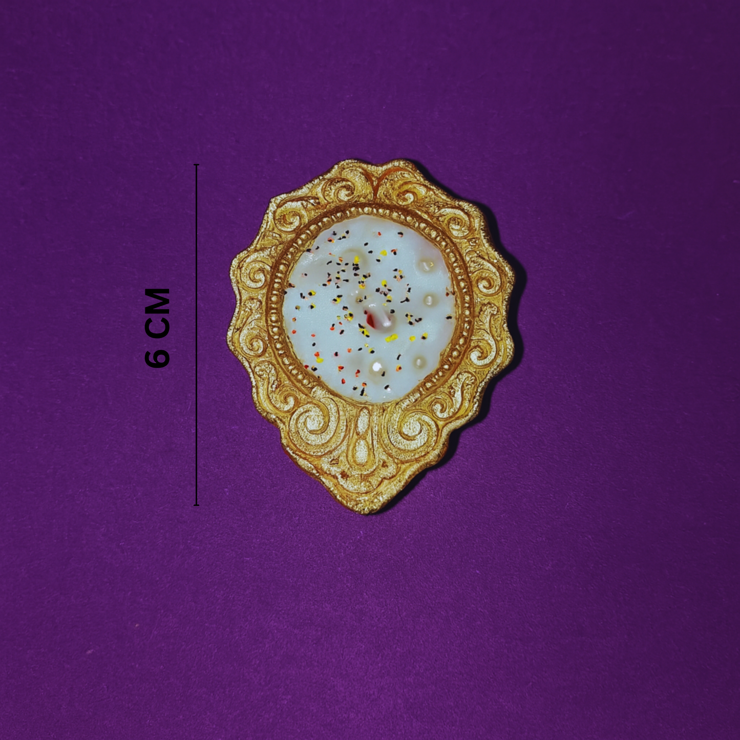 Golden Radiance Diya Fragrant Candle by Karigar Kutir — 6 cm handcrafted soy wax candle in ornate golden holder with glitter detailing, displayed on a purple background for size and product reference.