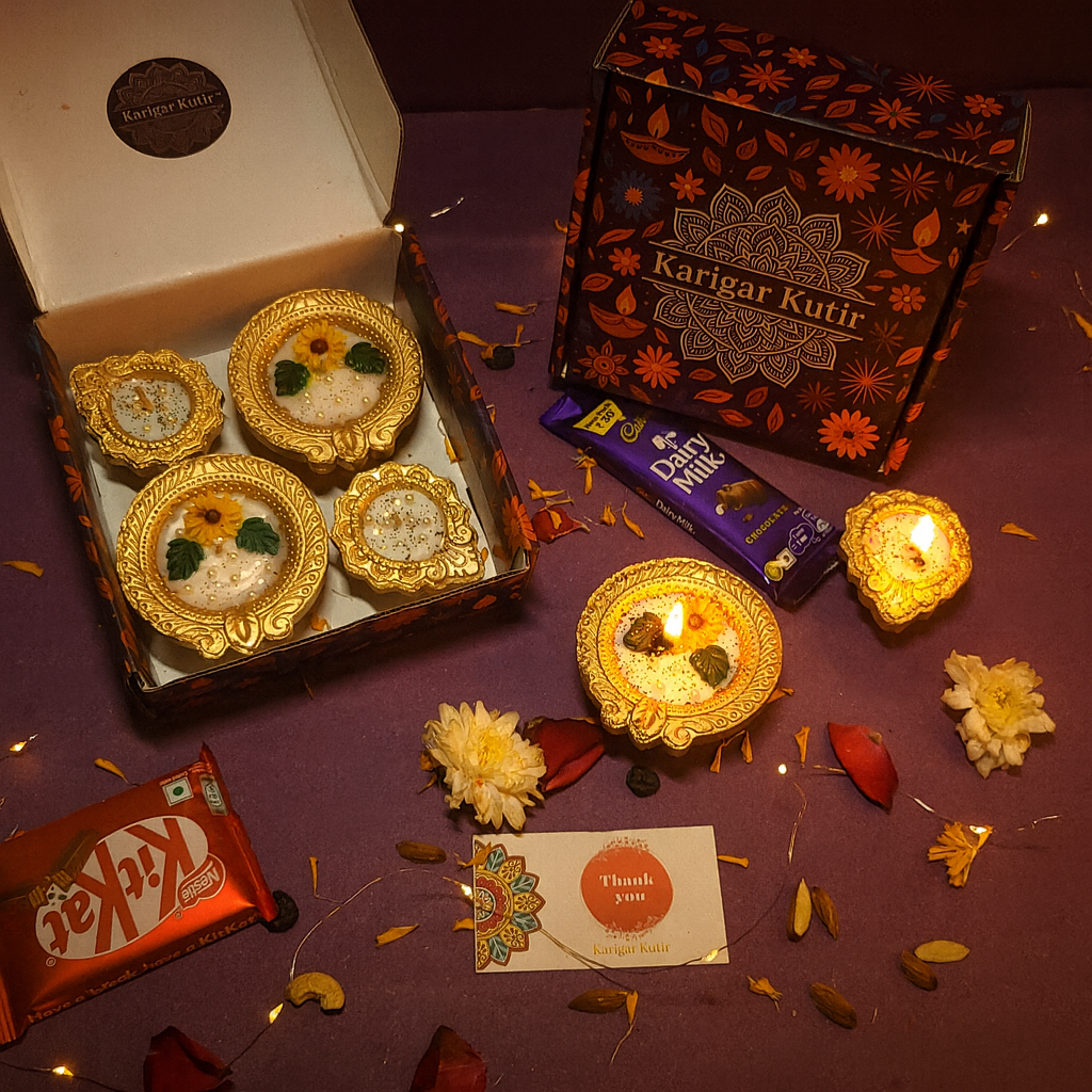 Golden Radiance Diya Fragrant Candle Gift Set by Karigar Kutir — handcrafted soy wax candles in golden holders with floral detailing, beautifully packed with chocolates, thank-you card, and festive décor elements for Diwali gifting.