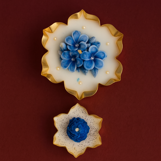 “Neel Pushp Urli Candle Set — two handcrafted blue floral soy wax candles in golden petal-shaped bowls, elegant design for Diwali and festive home décor.”
