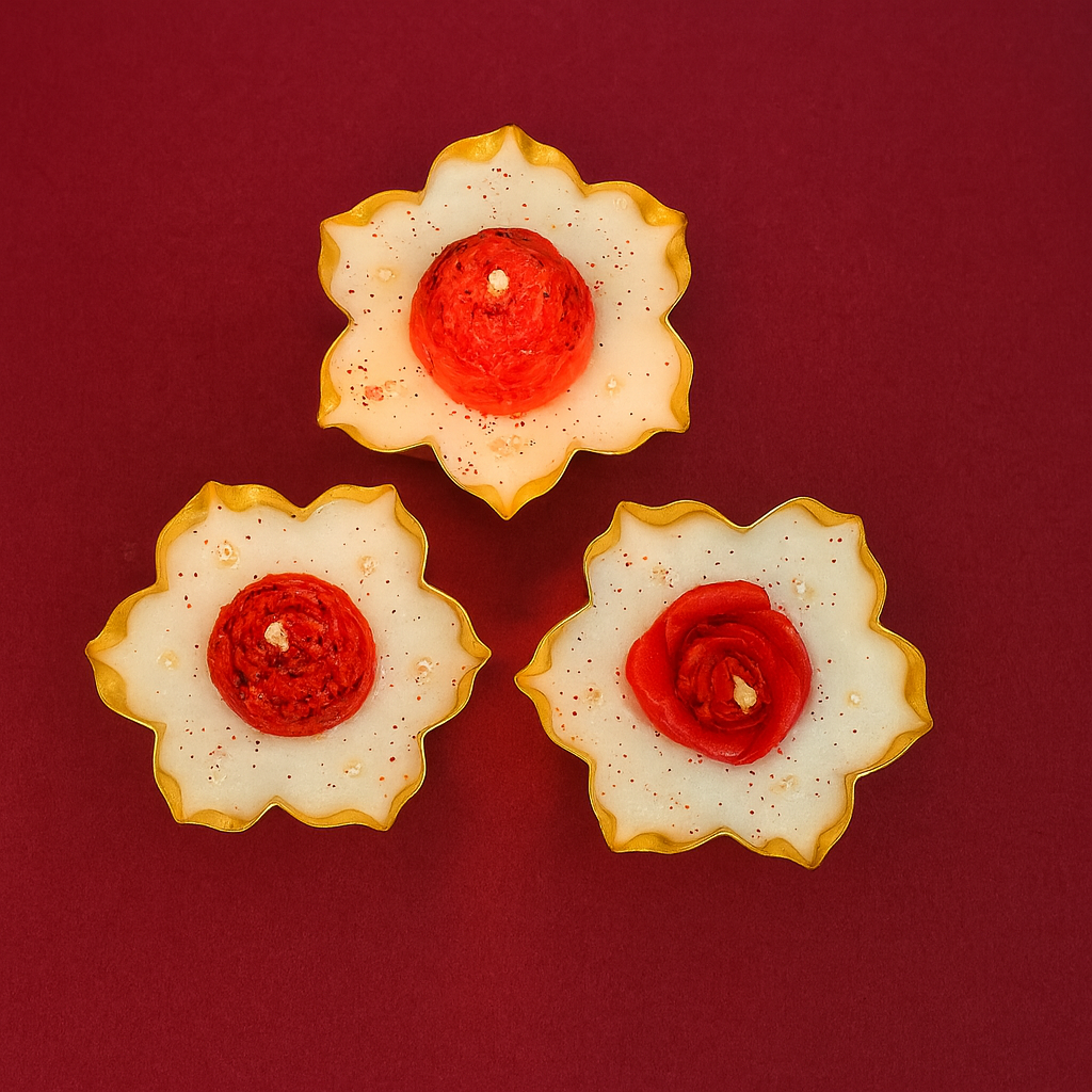Set of three handcrafted red rose urli candles in golden petal bowls — elegant soy wax collection for Diwali decoration and festive gifting by Karigar Kutir